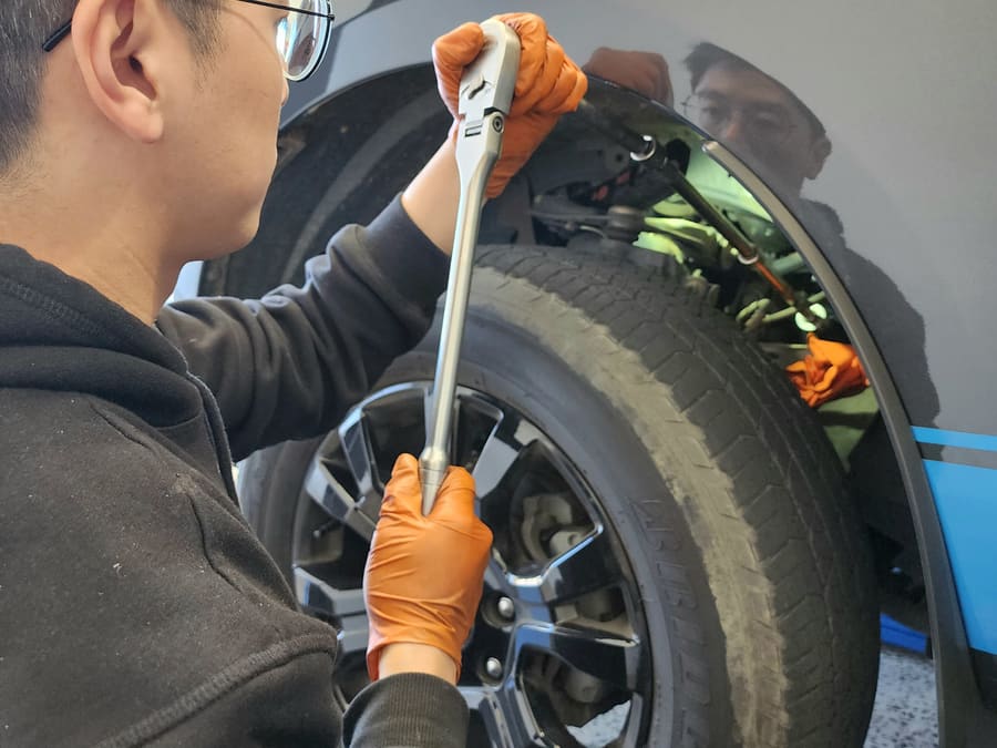 Technician removing a wheel for brake work